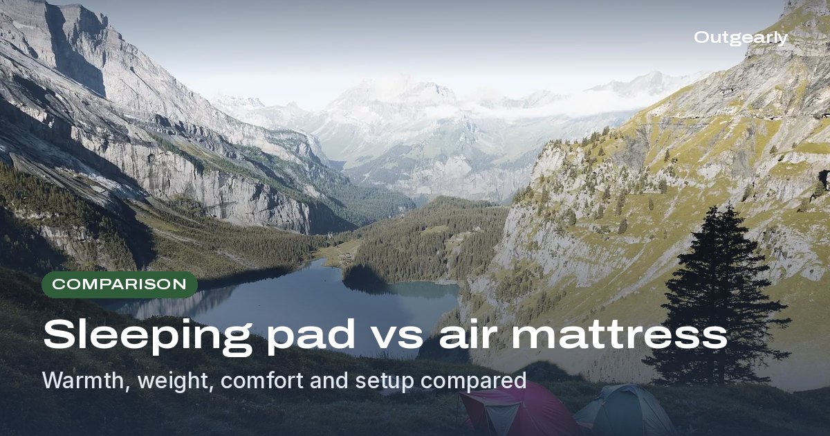 Comparison: Pink and teal tents pitched on a grassy alpine slope above a mountain lake